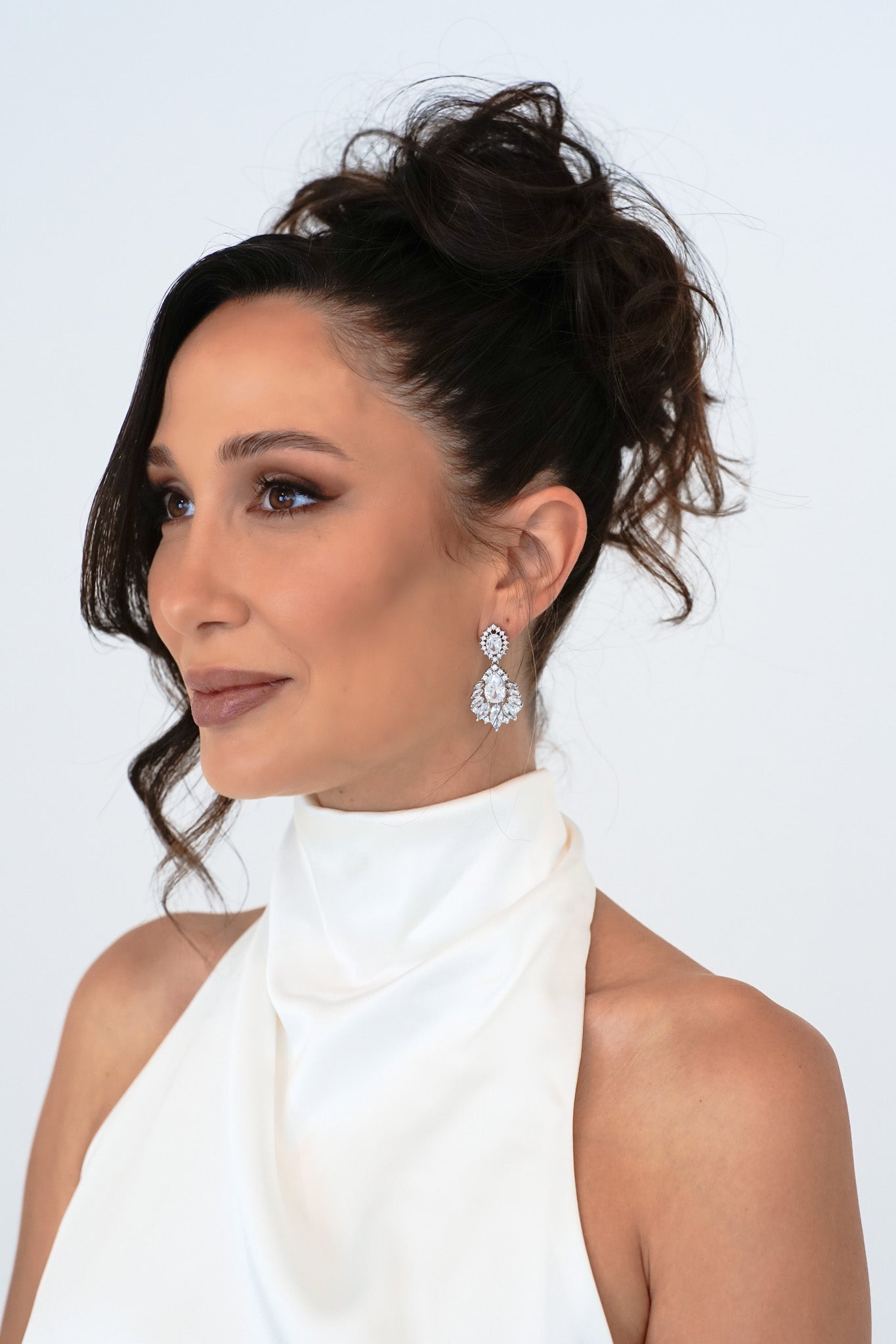 Woman in bridal gown with veil wearing Bella Earrings – elegant crystal chandelier drop style