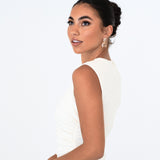 Bride with updo wearing Bianca Earrings – arms raised in playful pose, soft white backdrop