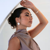 Bridesmaid in purple dress wearing the Anika Earrings