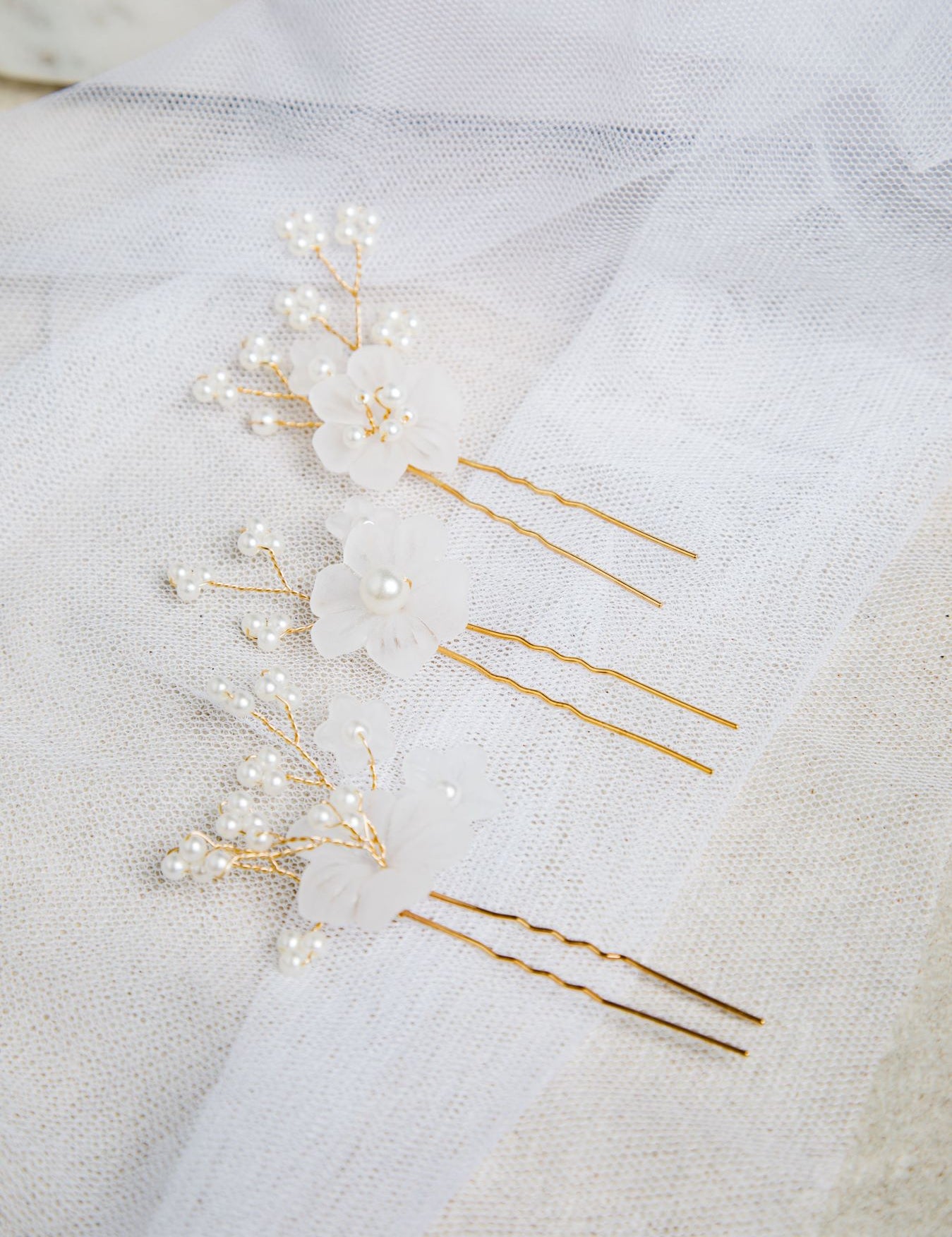 Close-up of Beth Hair Pins on mesh fabric – showcasing pearl buds and twisted silver wire details