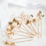Milan Hair Pins – gold leaf and pearl hair accessories arranged on fine white cloth