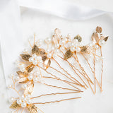 Milan Hair Pins – gold leaf and pearl hair accessories arranged on fine white cloth