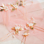 Milan Hair Pins – 7-piece set displayed on white mesh over soft pastel pink fabric