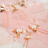 Milan Hair Pins – 7-piece set displayed on white mesh over soft pastel pink fabric