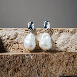 Kat Earrings – freshwater pearl drop earrings in silver on stacked brown pavers and grey background
