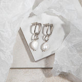 Sydney Earrings in silver – flatlay on marble tile with soft brown-grey floor and wrapping paper