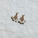 Loretta Earrings – sculptural pearl drop earrings displayed on mottled sand-coloured felt background
