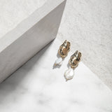 Leah Earrings – freshwater pearl drop earrings on white tile with vertical tile backdrop, soft grey felt background