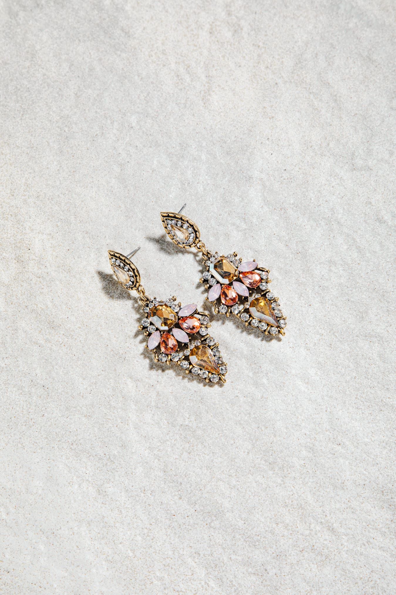 Alexia Earrings – prong-set vintage drop earrings in pink colourway on white textured background