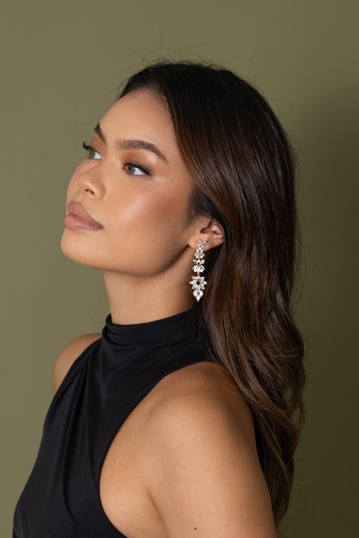 Woman in black halter dress wearing Jessica Earrings – side profile showing full earring drop