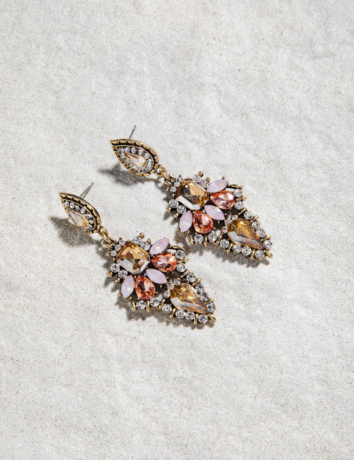 Alexia Earrings – prong-set vintage drop earrings in pink colourway on white textured background