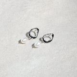 The Sophia Set earrings – silver open hoops with pearl drops on textured surface