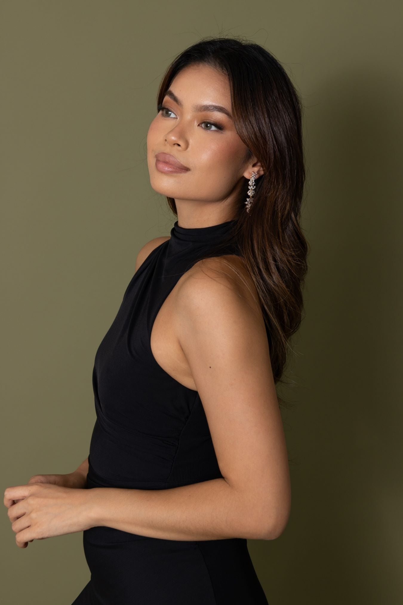 Woman in black halter dress wearing Jessica Earrings – side profile showing full earring drop