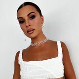 Model in white top showing the versatile Anika Earrings for casual wear