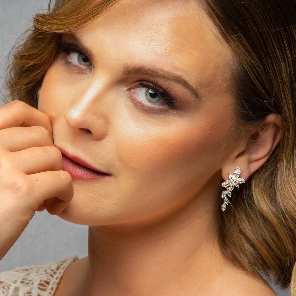 Woman wearing Gemma Earrings in silver – close-up bridal portrait with light brown hair and soft makeup.