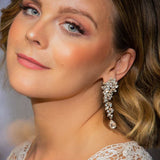 Bride wearing Marlo Earrings – blonde hair, lace gown, glowing makeup, looking into camera