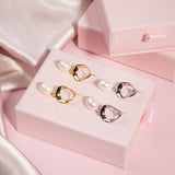 Gold and silver Sophia Earrings flatlay on pink gift box with pink background and shimmering pink fabric