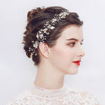 Bride wearing Nova Hairpiece with hair up, red lipstick, and long-sleeve floral lace gown – elegant bridal headshot